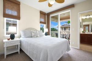a white bedroom with a bed and a balcony at Casa Makara in Princeville +17 photos