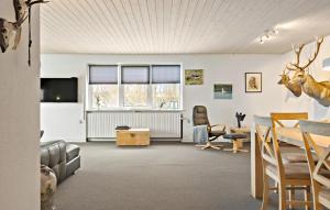 a living room with a table and chairs at 3 Bedroom Pet Friendly Home In Ulfborg in Ulfborg
