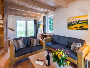 a living room with a couch and a table at Holiday Home Holiday Hill 65 by Interhome in Lauterwasser +48 photos