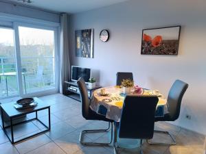 a dining room with a table and chairs at Studio Bowie with shared pool by Interhome in De Haan