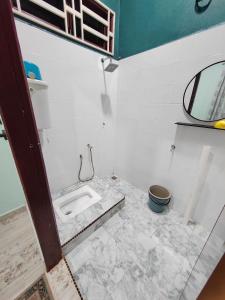 a bathroom with a sink and a mirror at Homestay Umar Homestay Tilam Hotel in Bachok