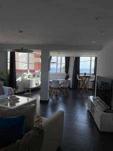 a living room with a couch and a tv at Serenity by levante beach (YAGO), 7pax wi-fi A\C in Benidorm +74 photos