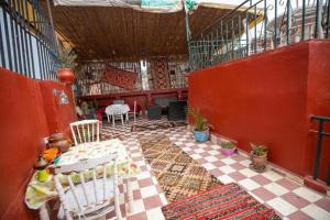 a patio with chairs and tables in a building at Riad Fez Hostel in Fez