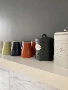 a shelf with different colored containers on it at Serenity by levante beach (YAGO), 7pax wi-fi A\C in Benidorm