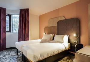 a hotel room with a bed and a window at B&B HOTEL Paris Porte de Châtillon in Châtillon