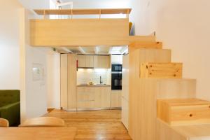 a small apartment with a staircase and a kitchen at Vinum Apartament 1890 in Coimbra