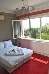 a bedroom with a bed with a large window at No20 Hotel Sultanahmet in Istanbul