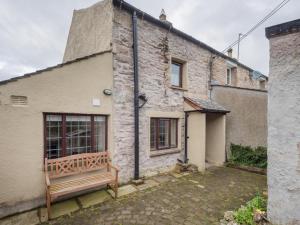 a brick house with a bench in front of it at 2 Bed in Ravenstonedale SZ141 in Ravenstonedale