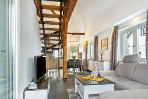 a living room with a couch and a table at Ameisberger - Landhaus in Mollmannsreith