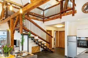 a staircase in a kitchen with wooden beams at Ameisberger - Landhaus in Mollmannsreith