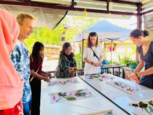 a group of people standing around a table with cakes at Banhalawee in Ko Yao Yai