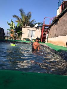 a man standing in the water at a water park at Ingawale farmhouse (agro tourism) in Satara