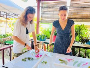 two women standing at a table preparing food at Banhalawee in Ko Yao Yai