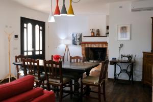 a dining room with a table and chairs and a fireplace at Il Colle di Torre Orsina in Torre Orsina