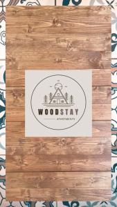 a wooden box with a woody logo on it at Woodstay Apartments in Orestiada