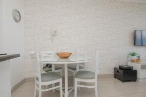 a white table and chairs in a room with a wall at 423 Breakers Resort in Durban
