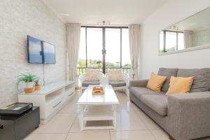 a living room with a couch and a table at 423 Breakers Resort in Durban