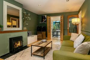 a living room with a couch and a fireplace at Stunning 3BD Oxfordshire Cottage in Enstone in Enstone