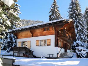 a log cabin in the snow with a picnic table at Chalet Chalet Le Haut Pré by Interhome in Villars-sur-Ollon