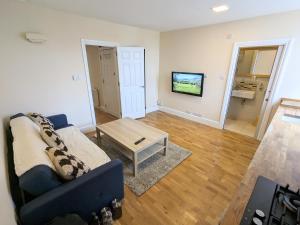 a living room with a couch and a coffee table at Guildford Station with Parking in Stoughton