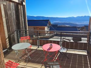a balcony with two tables and chairs on a roof at Chalet Nobel Centre ville 8 pers - 4 Chambres - 4 SdB in Font-Romeu +4 photos
