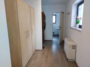 a room with a hallway with wooden floors and a radiator at Apartment Landhaus St- Georg-2 by Interhome in Bad Gastein
