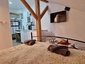 a bedroom with a bed with towels on it at AIRPORT APARTMENS President and Black&White in Velika Gorica