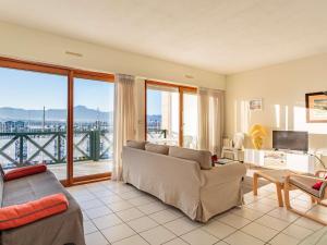 a living room with a couch and a balcony at Appartement Hendaye, 2 pièces, 6 personnes - FR-1-2-350 in Hendaye