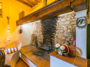 a stone fireplace in a living room with yellow walls at Holiday Home Sole by Interhome in San Casciano in Val di Pesa