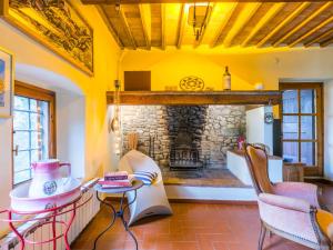 a room with a stone fireplace with a table and chairs at Holiday Home Sole by Interhome in San Casciano in Val di Pesa +68 photos
