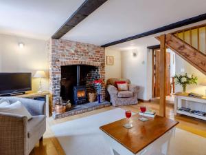 a living room with a brick fireplace and a table at 2 Bed in Cerne Abbas BRAMC in Cerne Abbas