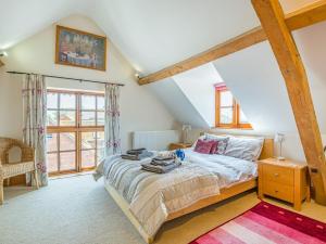 a bedroom with a bed and a large window at 4 bed in Cheltenham 41216 