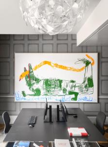 a table in a room with a painting on the wall at Boutique & Art Hotel Helvetia in Zürich
