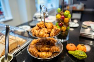 a buffet with three tiers of pastries on a table at Cabinn Plus Esbjerg in Esbjerg