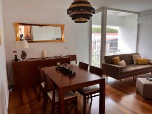 a living room with a table and a couch at Apartamento Vitória in Praia da Vitória