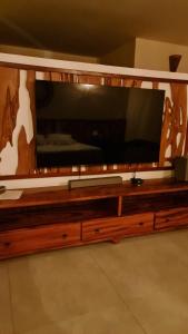 a large entertainment center with a large television on it at Illuminare Stile in Fortim