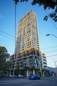 a tall building with a blue car parked in front of it at 1 BRM 1 BATH, South Melbourne, Spacious, Balcony in Melbourne