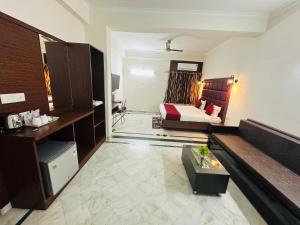 a hotel room with a bedroom and a bed at Sheela Homestay in Agra