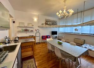 a kitchen with a table and a dining room at Art District Loft Venice in Venice +14 photos