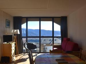 a living room with a large window with a view at Charmant 2 pièces cabine au centre de Font-Romeu, parking inclus - FR-1-580-96 in Font Romeu Odeillo Via +2 photos