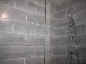 a bathroom with a shower with a glass door at Charmant 2 pièces cabine au centre de Font-Romeu, parking inclus - FR-1-580-96 in Font Romeu Odeillo Via