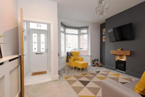 a living room with a door and a yellow chair at Belgrave in Darlington