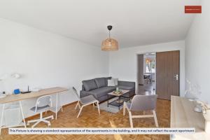 a living room with a couch and a table and chairs at Practical Living Space 