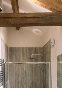 a bathroom with a shower with a wooden ceiling at Union Farm Cottage in Reeth