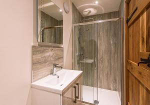 a bathroom with a sink and a shower at Union Farm Cottage in Reeth +39 photos