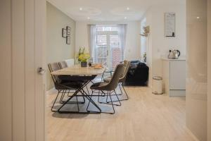 uma cozinha e sala de jantar com mesa e cadeiras em Stunning 2 Bed with Private Patio and Free Parking em Cheltenham