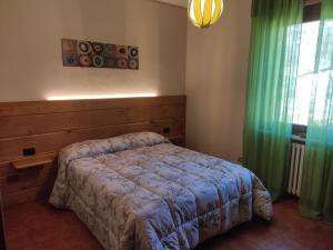 1 dormitorio con cama y ventana en Cà di Candi en Demonte