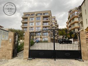 a black gate with a car in front of a building at habitat Sea View Apartment Varna in Varna City