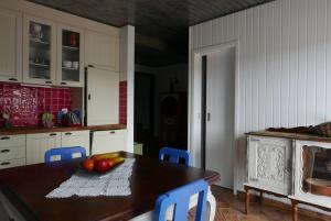 a kitchen with a table with a bowl of fruit on it at Barranco do Zambujeiro in Vila do Bispo