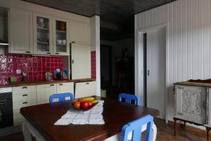 a kitchen with a table with a bowl of fruit on it at Barranco do Zambujeiro in Vila do Bispo +12 photos